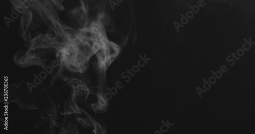closeup vapor stream rises from bottom center on black background photo