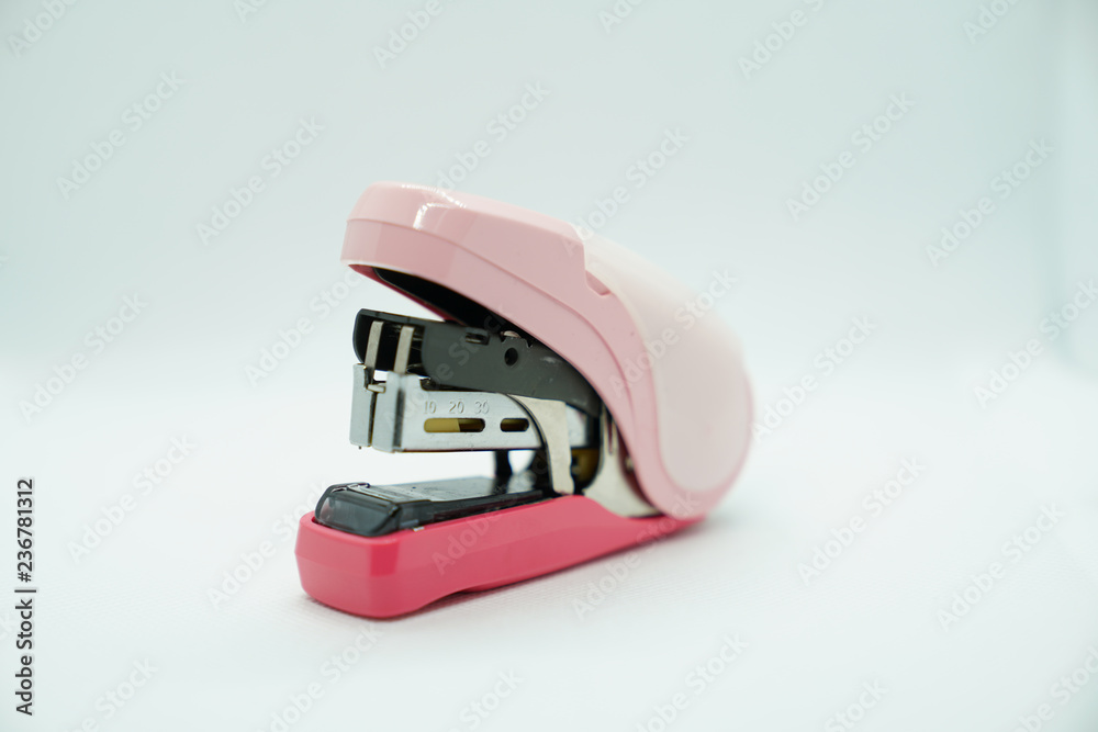KELANTAN, MALAYSIA, - NOVEMBER 28, 2018 : A stapler is a mechanical device that joins pages of paper or similar material by driving a thin metal staple through the sheets On White Background. KELANTAN, MALAYSIA, - NOVEMBER 28, 2018 : A stapler is a mechanical device that joins pages of paper or similar material by driving a thin metal staple through the sheets On White Background.