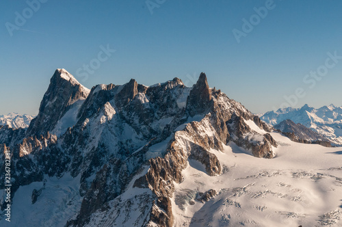 View over the French Alps, from the Aiguille du Midi cable on a winter afternoon, just before Christmas.