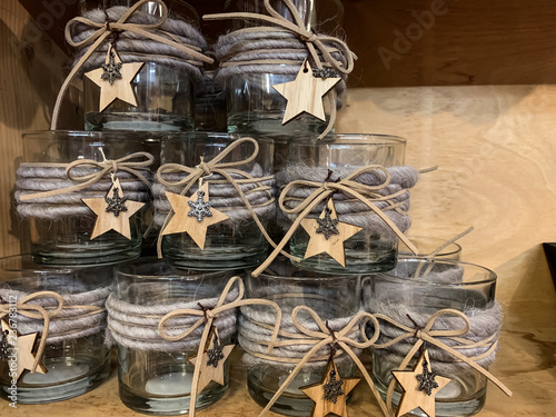Glass cans on a wooden shelf. Dishes. Festive decorations.