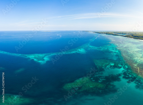Aerial view coral reef scattered in caribbean sea, tropical beach islands. Indonesia Moluccas archipelago, Kei Islands, Banda Sea. Top travel destination, best diving snorkeling, stunning panorama.
