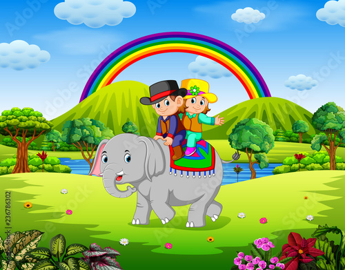young couple riding elephant in beautiful nature