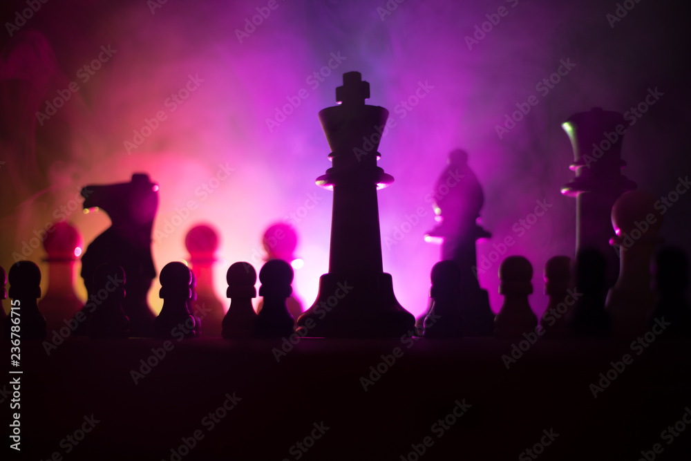 Chess board game concept of business ideas and competition or strategy ideas concept. Chess figures on a dark toned foggy background. Chess board game concept of business ideas and competition or strategy ideas concept. Chess figures on a dark toned foggy background.