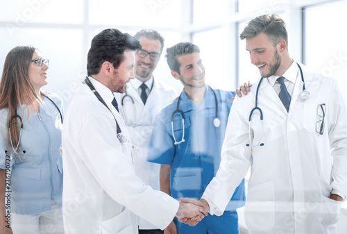 doctors shaking hands in hospital corridor