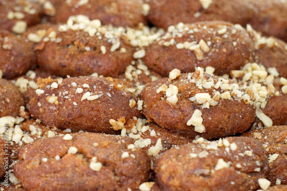 Close up selected focus of greek traditional chrstmas cookies (melomakarona), with honey syrup and walnuts