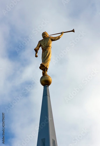Sculpture of angel moroni atop of a Mormon Temple. photo