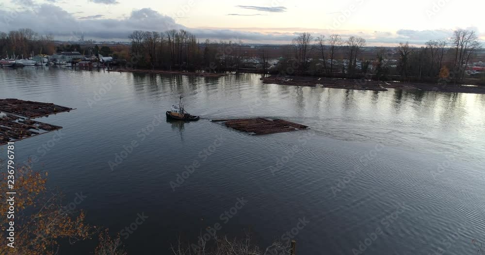 Log Boom Tug at River in Vancouver, Canada. Drone flying. Aerial 4k view. Log Boom Tug at River in Vancouver, Canada. Drone flying. Aerial 4k view.