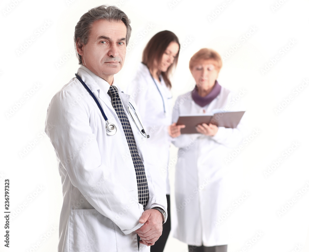 serious therapist doctor on blurred background of colleagues serious therapist doctor on blurred background of colleagues