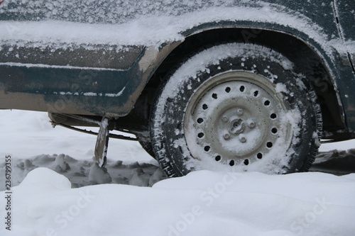 car wheel in snow after snowstorm