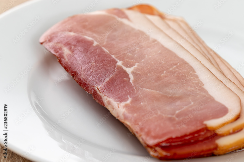 Close up of raw ham on a white plate