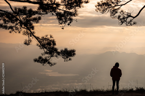 lonely woman standing at the cliff