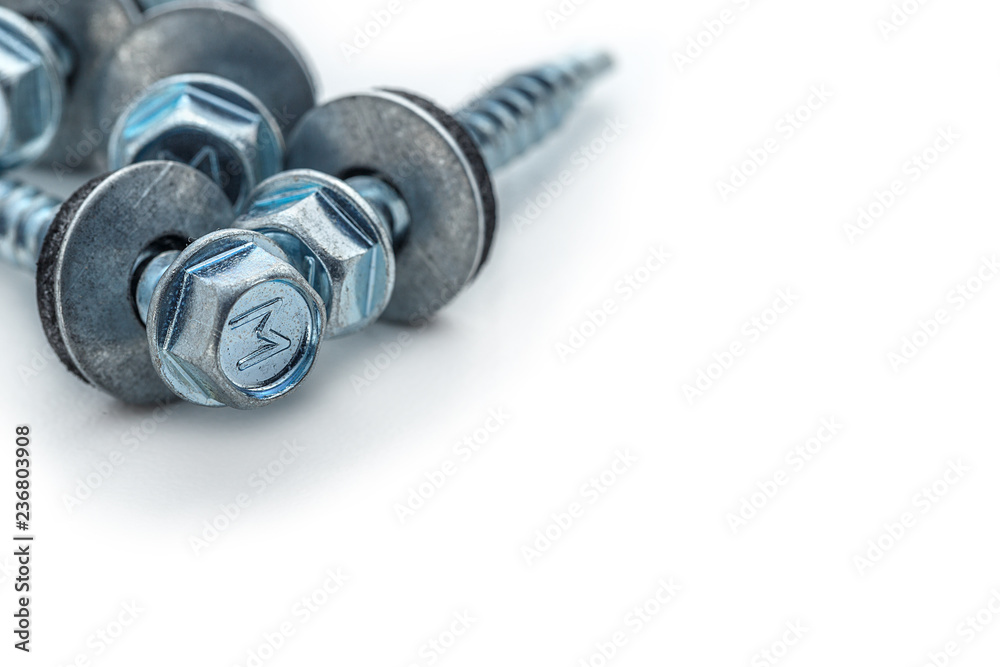 Metalware, roofing screw or tapping screw, fasteners isolated on white background closeup. Metallic hardware. Metalware, roofing screw or tapping screw, fasteners isolated on white background closeup. Metallic hardware.