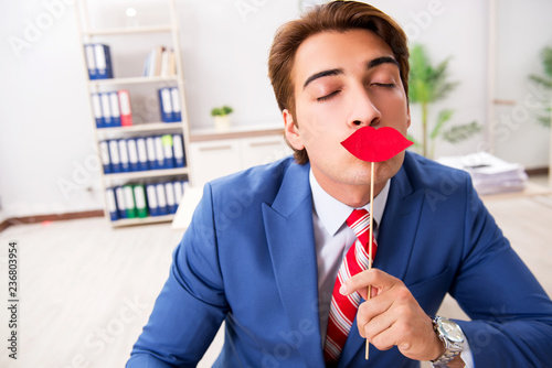 Funny bisinessman with fake lips in the office photo