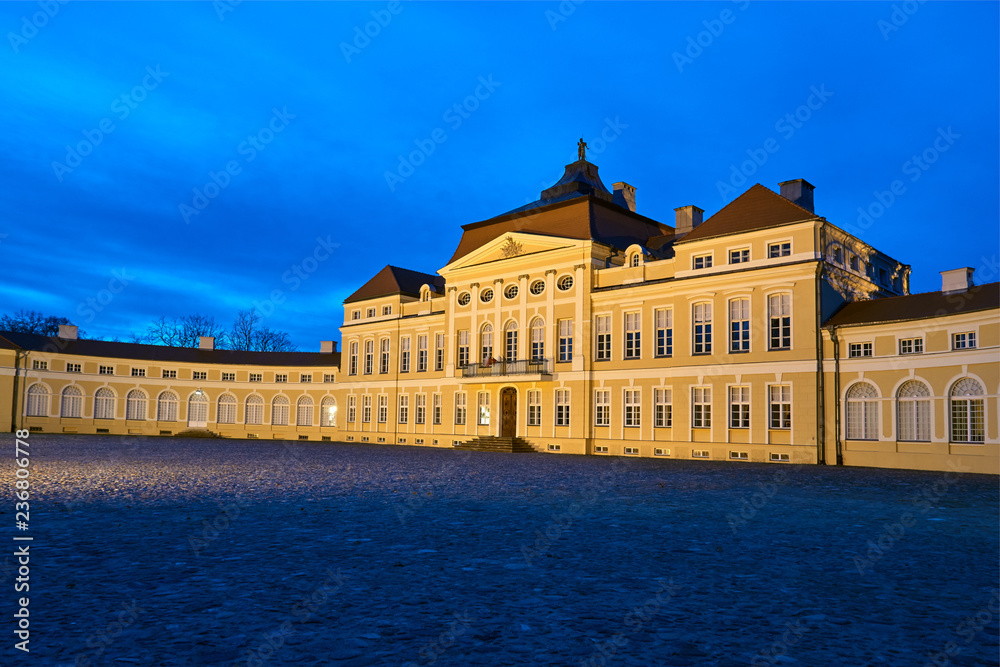 night view of the illuminated elevation of the baroque historic palace in Rogalin.