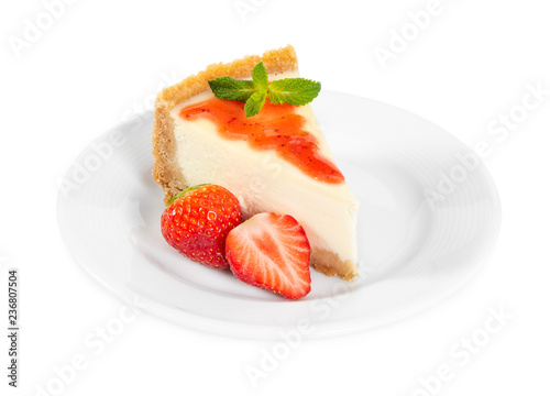 Piece of cheesecake with fresh strawberries and mint