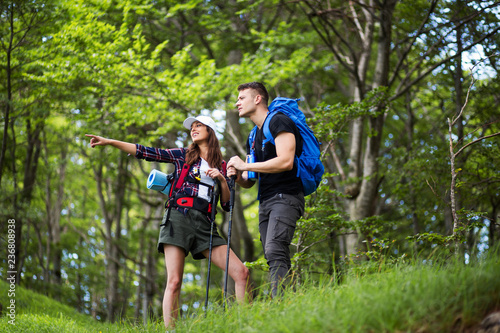 Couple with backpack enjoying at hiking trip