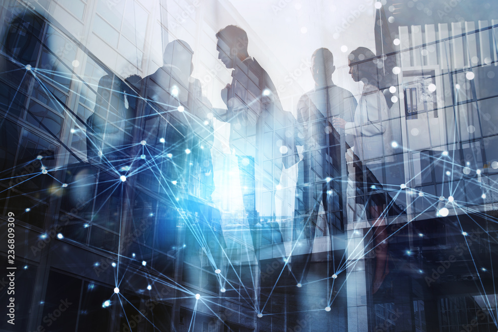 © alphaspirit - Silhouette of business people working together in office. Concept of teamwork and partnership. double exposure with network effects