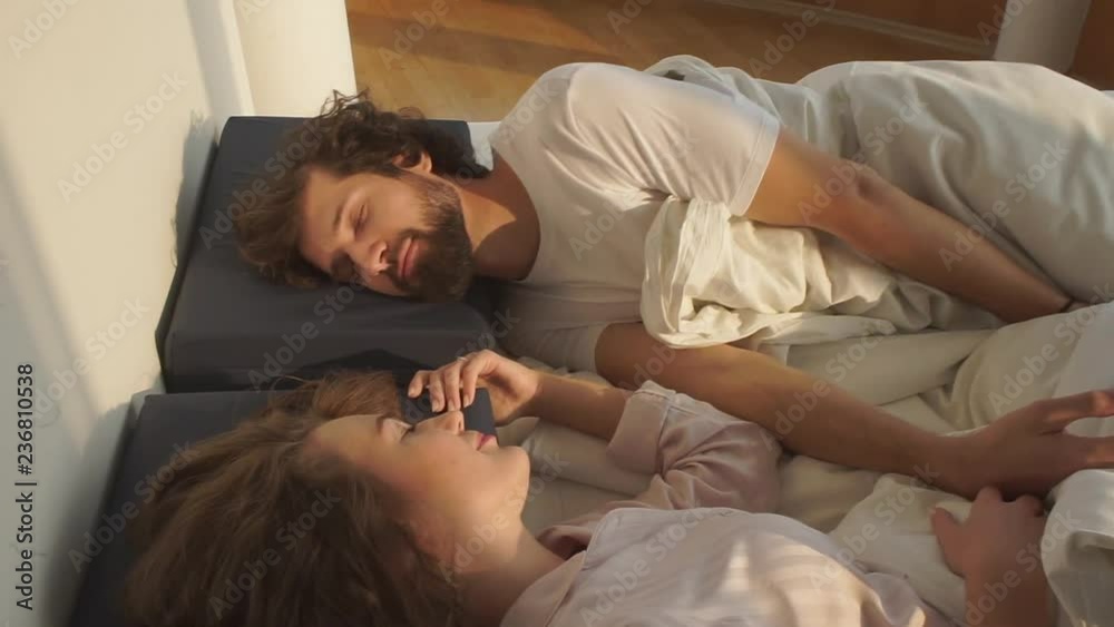 Couple lying on the bed looking at each other. Self-expression at home. Social distance. Comfort. Couple lying on the bed looking at each other. Self-expression at home. Social distance. Comfort.