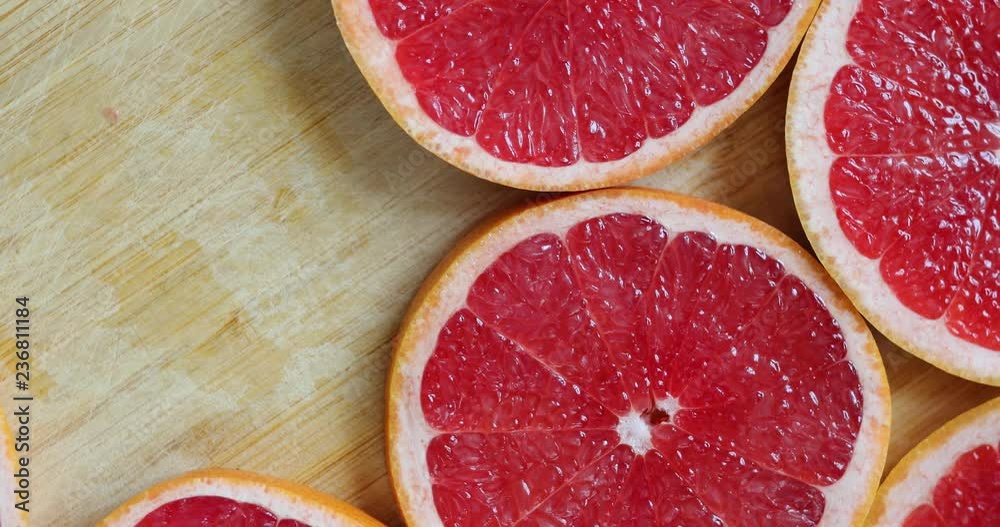 Take one fruit while grapefruits rotating, top view
