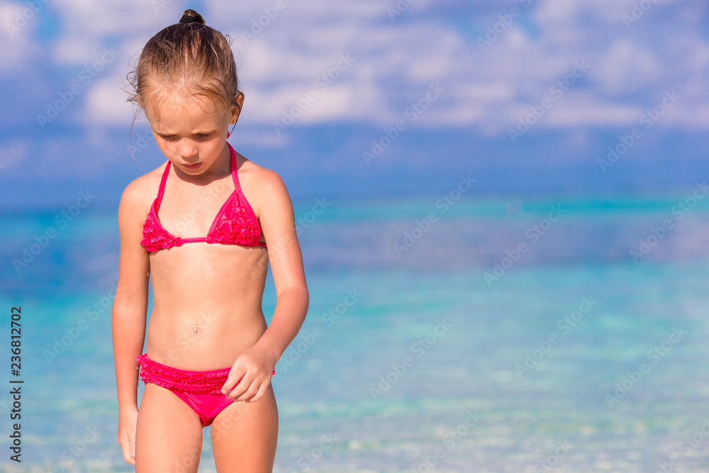 Adorable little girl at beach during summer vacation