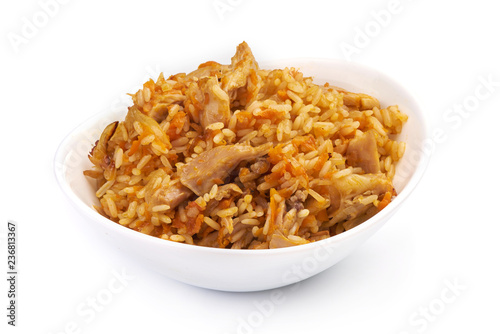 Uzbek restaurant concept. Uzbek pilaf made from beef, lamb, chicken, in a cup, isolated on a white background