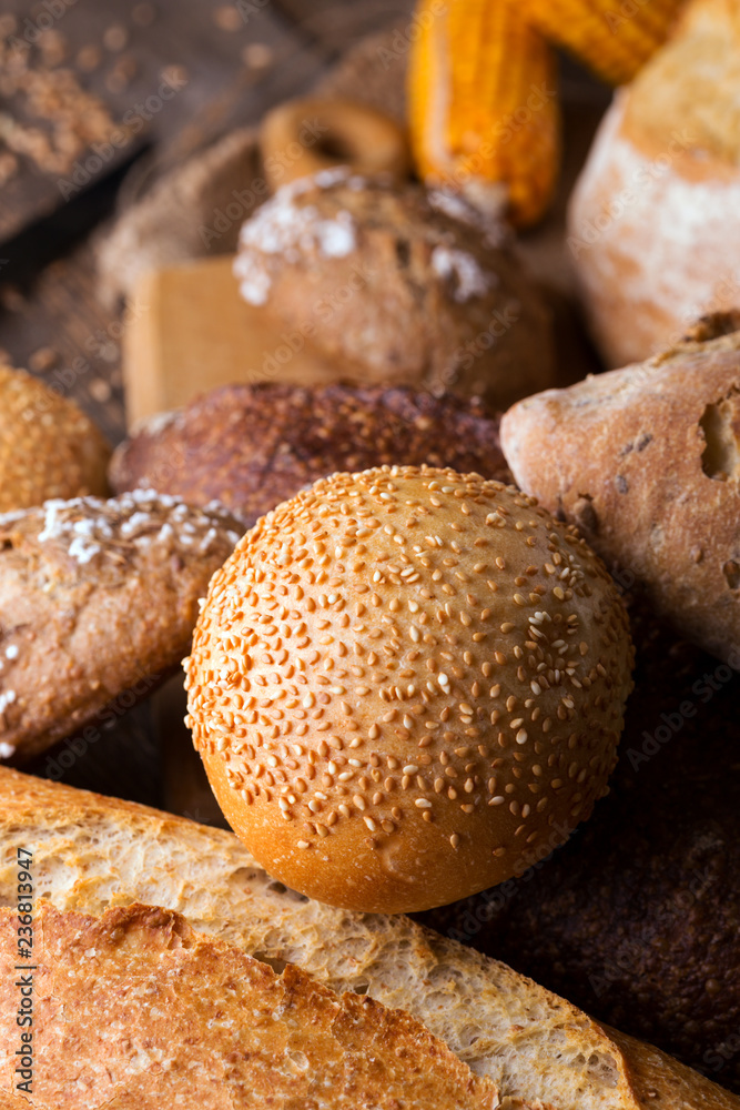 Fototapeta premium fresh bread and wheat on the wooden