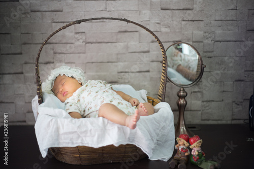 Infant sleep on gentle bed and look like she have a sweet dream