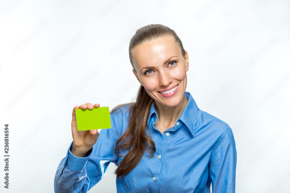 Beautiful business woman is smiling and holding a card in her hand. Beautiful business woman is smiling and holding a card in her hand.