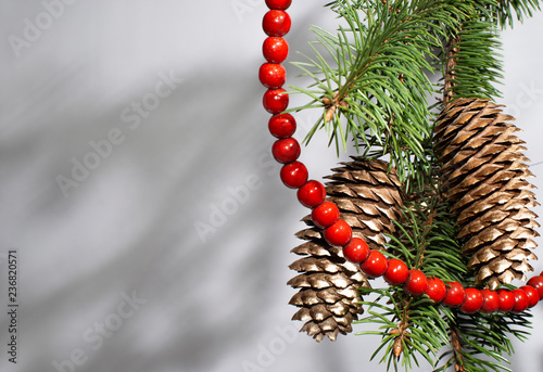 Christmas tree with gold pine cones and red beads