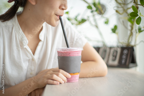 Woman drinking smoothie made of super foods