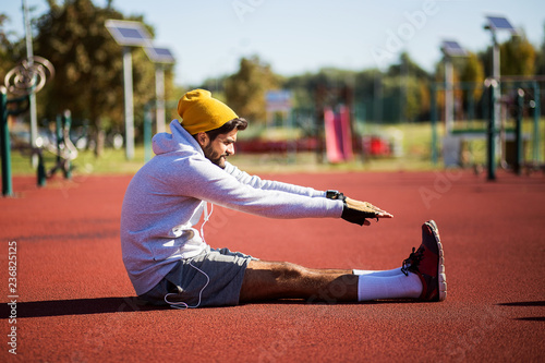 Young sports man stretching