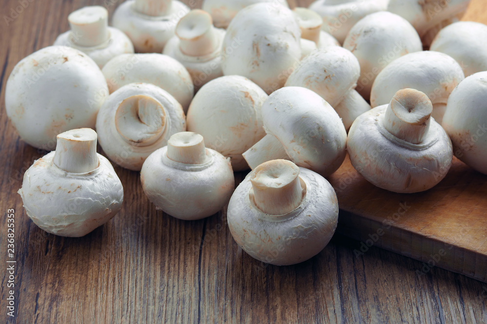 white champignons on the cutting table