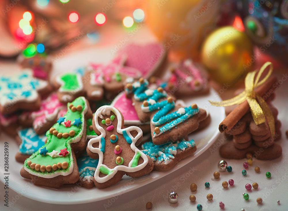 Christmas gingerbread cookies decorated with colored frosting for new year, Christmas party, winter holiday, sweet home gift for kids. Balls and garlands Christmas background.