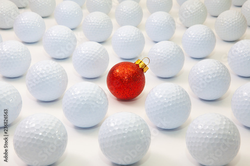 Pattern with white golf balls and red Christmas decoration