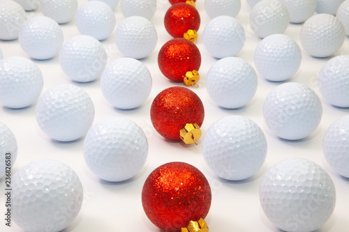 Pattern with white golf balls and red Christmas decoration