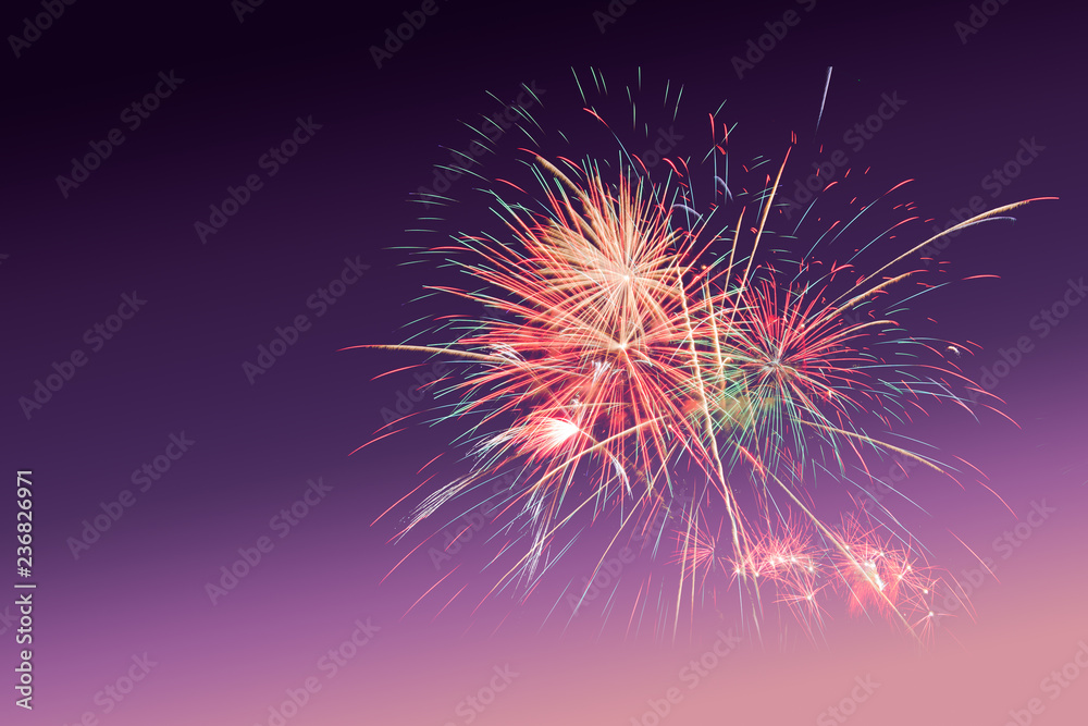 Colourful Fireworks on purple sunset twilight background with copy space to celebrate happy new year or special occasions Colourful Fireworks on purple sunset twilight background with copy space to celebrate happy new year or special occasions