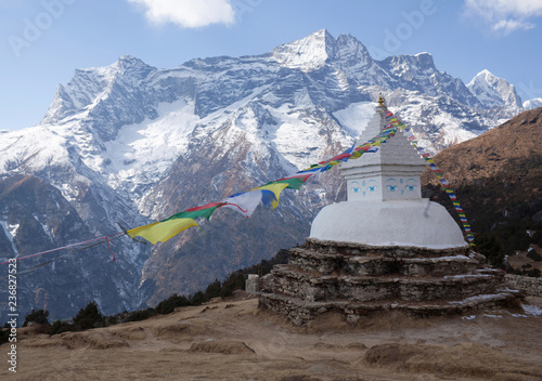 Buddhist white stupa with prayer flags above Namche Bazaar in Nepal Himalayas