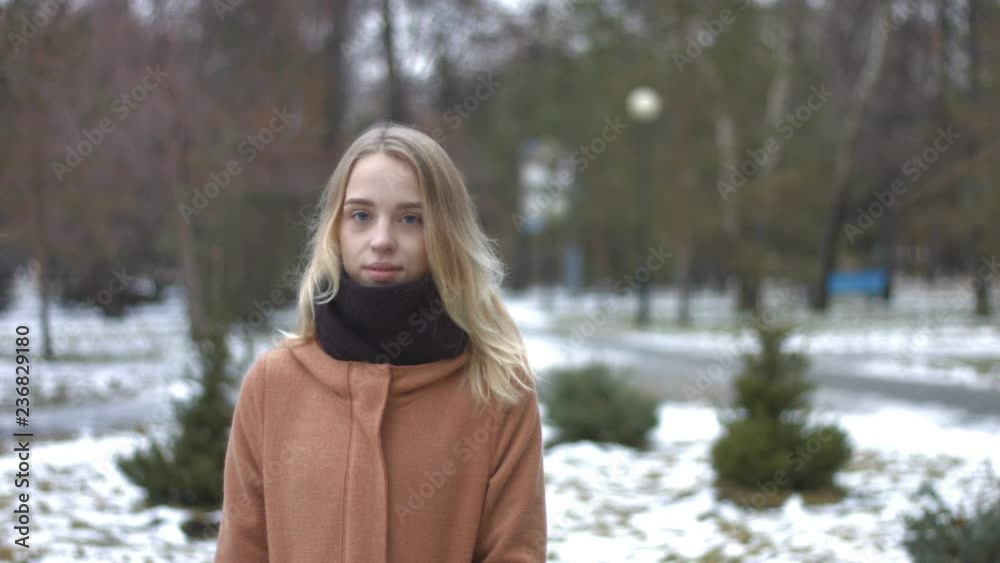 Girl in snowy park.
Warmly dressed girl gently looks at the camera and then laughs. On the background are trees and benches. Snowy weather. Girl in snowy park.
Warmly dressed girl gently looks at the camera and then laughs. On the background are trees and benches. Snowy weather.
