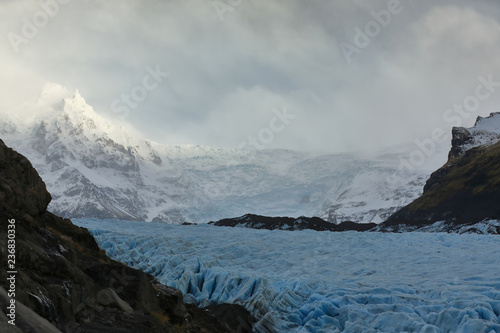 View of a glacier, background snowy mountains in Iceland
