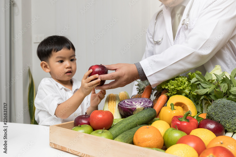 Children and doctors happy to have healthy food.Kid learning about nutrition with doctor to choose eating fresh fruits and vegetables.