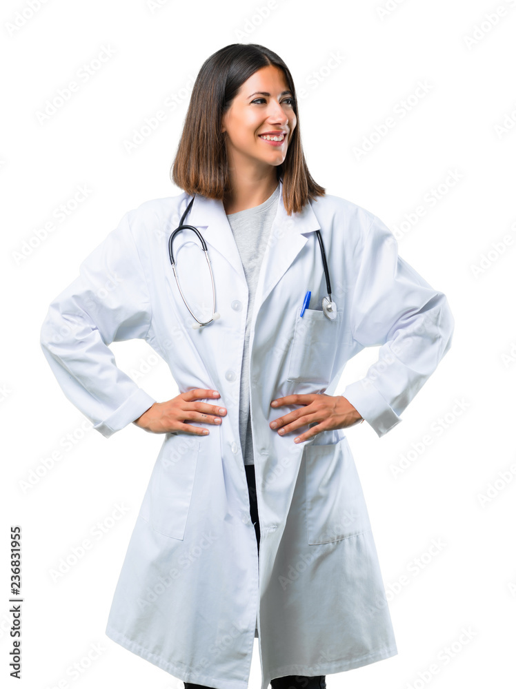 Doctor woman with stethoscope posing with arms at hip and laughing on isolated white background Doctor woman with stethoscope posing with arms at hip and laughing on isolated white background