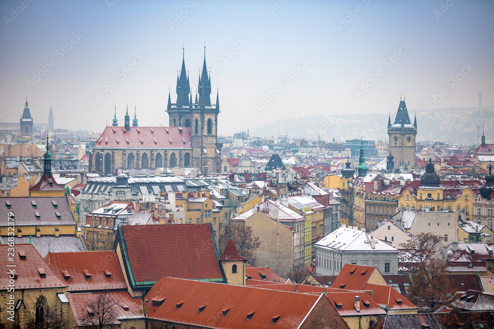 View of Old Town Prague City in snowy foggy day in the winter, Czech republic