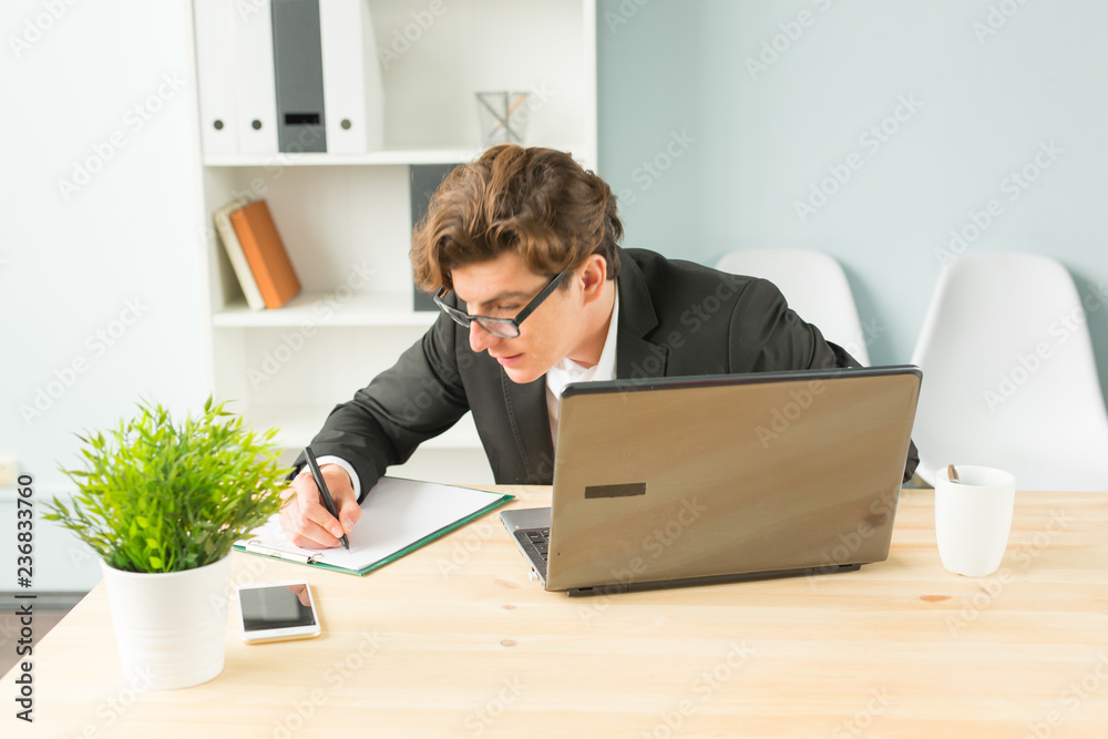 Office, joke and business people concept - young man is fun and enthusiastic working in the office
