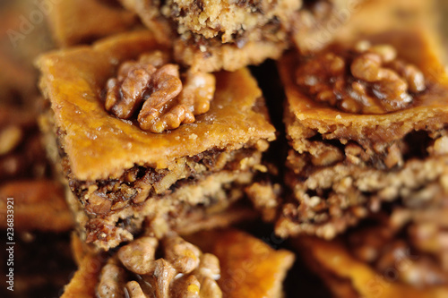 appetizing baklava with nuts and honey closeup on a wooden background