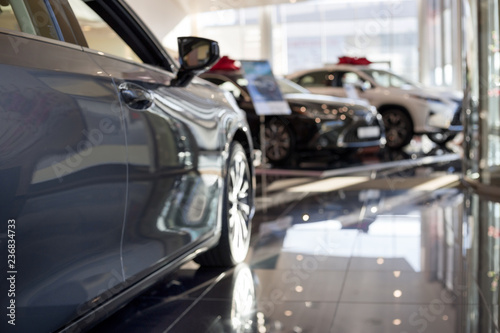 Car auto dealership.Themed blur background with bokeh effect. New cars at dealer showroom.