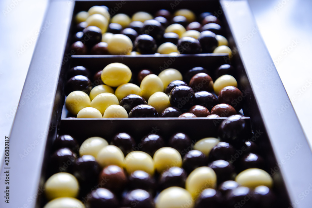Chocolate candies closely. Mixed chocolate dragee of two colors yellow, brown. Macro food photo for design, web, market, shop, cafe, restaurant, food calendars. Sugar, teatime. Romantic bokeh effect Chocolate candies closely. Mixed chocolate dragee of two colors yellow, brown. Macro food photo for design, web, market, shop, cafe, restaurant, food calendars. Sugar, teatime. Romantic bokeh effect