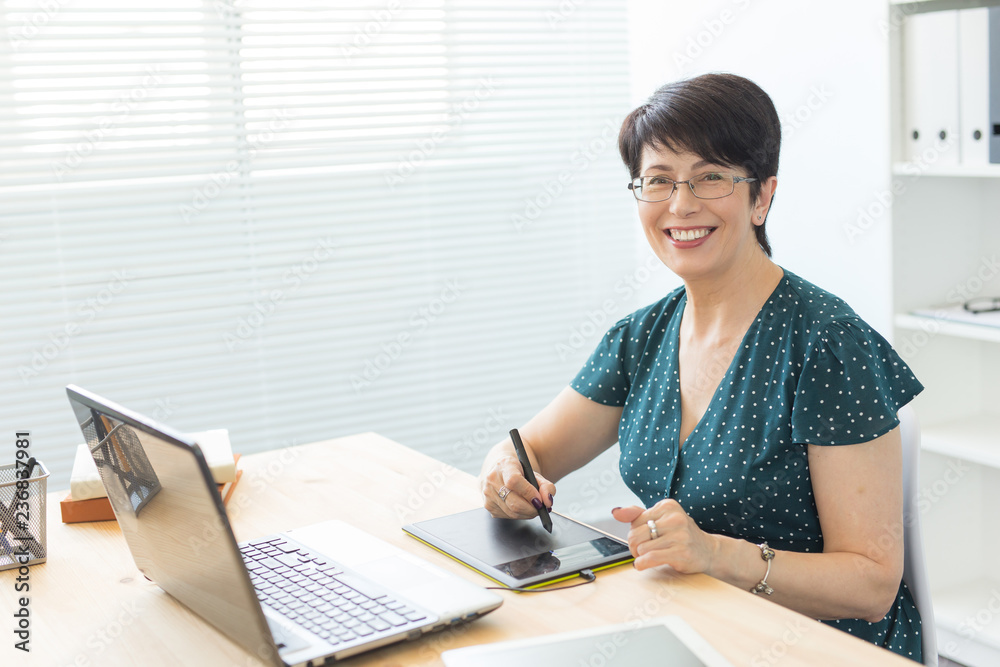 Illustrator, web designer and artist concept - Graphic designer using her pen tablet in a bright office Illustrator, web designer and artist concept - Graphic designer using her pen tablet in a bright office
