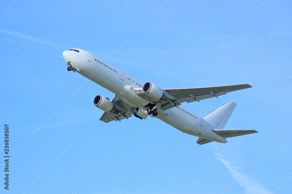 white airplaine 767 airborne take off into blue skies white airplaine 767 airborne take off into blue skies