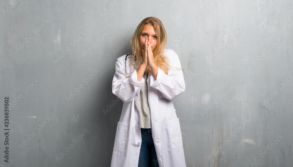 Young doctor woman keeps palm together. Person asks for something Young doctor woman keeps palm together. Person asks for something
