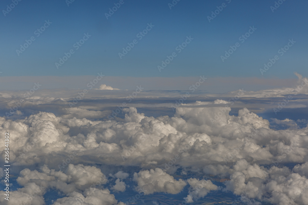 Naklejka premium Sea of clouds, seen from the window of an airplane